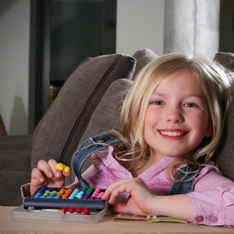 Smart Games IQ Fit educational puzzle toy with colorful beads on an abacus-style board, child playing.