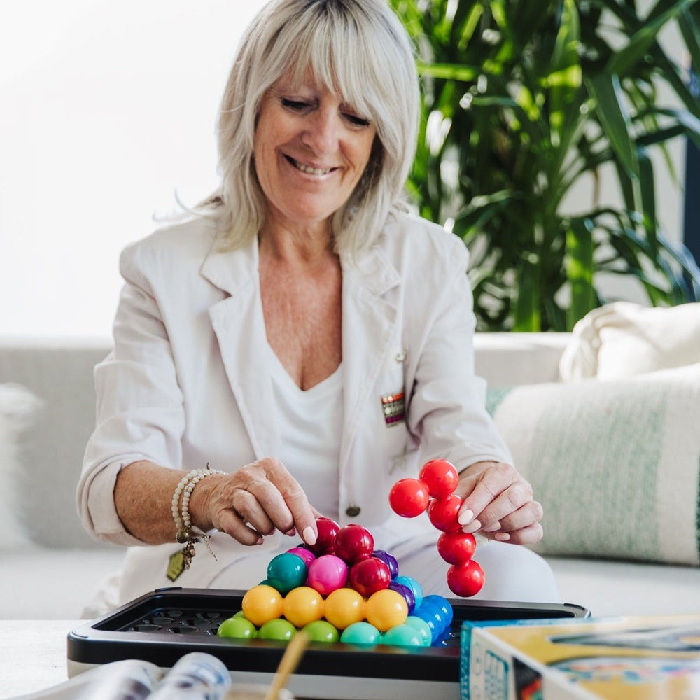 Smart Games IQ Puzzler Pro XXL puzzle toy with colorful bead spheres in a black tray