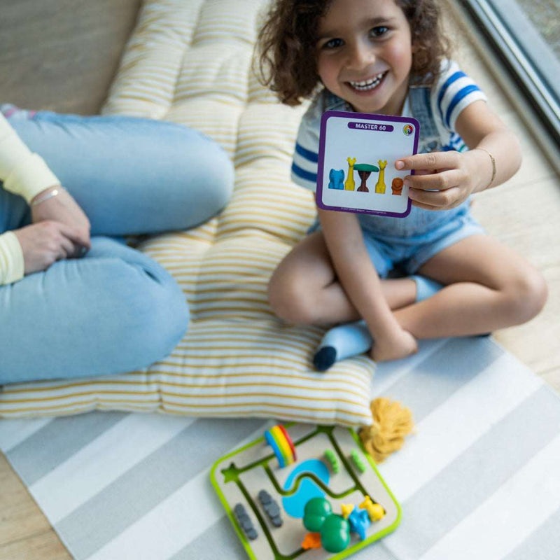 Smart Games Safari Park Jr. educational toy set on a bright green tray with colorful safari pieces