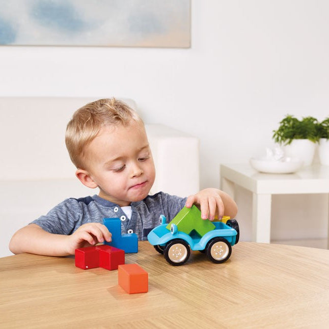 Smart Games Smartcar 5X5 toy car set, blue body with green roof, playing with three colorful blocks.