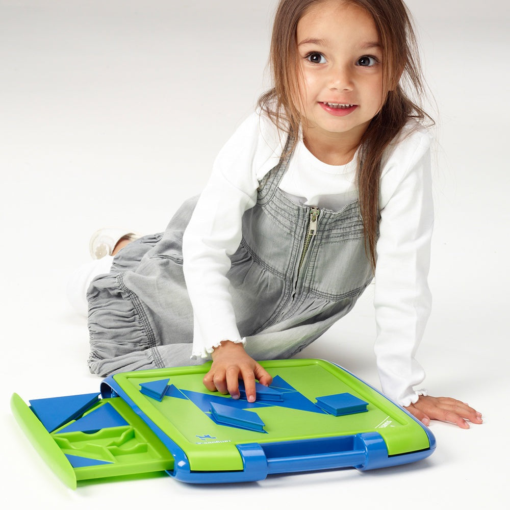 Tangoes Jr magnetic puzzle board by SMART GAMES, green and blue, with a young girl playing