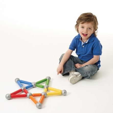 SmartMax 42pcs magnetic construction set multicolor rods with silver spheres beside a smiling child
