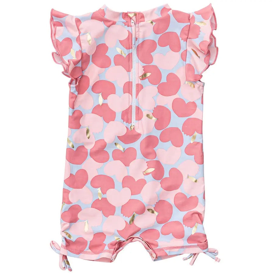 Snapper Rock Apple Love Flutter Sleeve Sunsuit in pink/blue hearts, featuring a front zipper and tied leg openings.