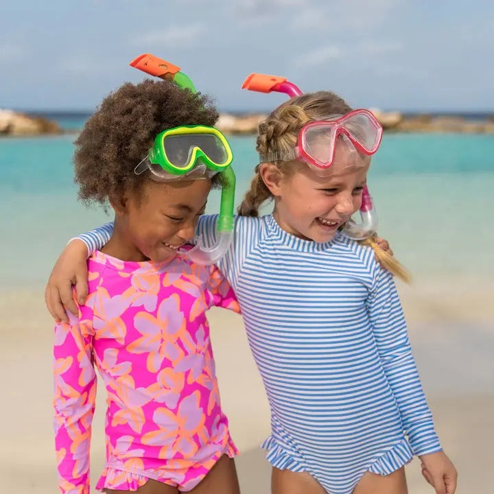 Snapper Rock Cornflower Stripe Surf Suit, blue-and-white striped toddler one-piece, worn by two kids snorkeling at the beach.