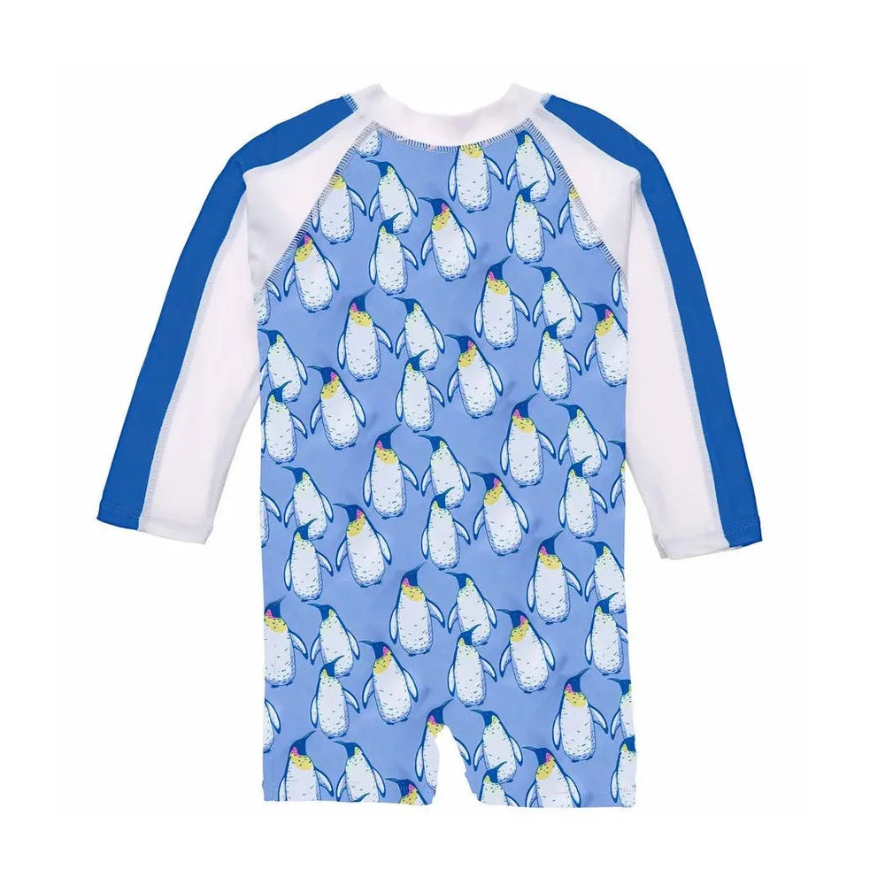 Snapper Rock Penguin Patrol LS Sunsuit in blue with white sleeves and penguin print, laid flat to show sun-safe coverage.