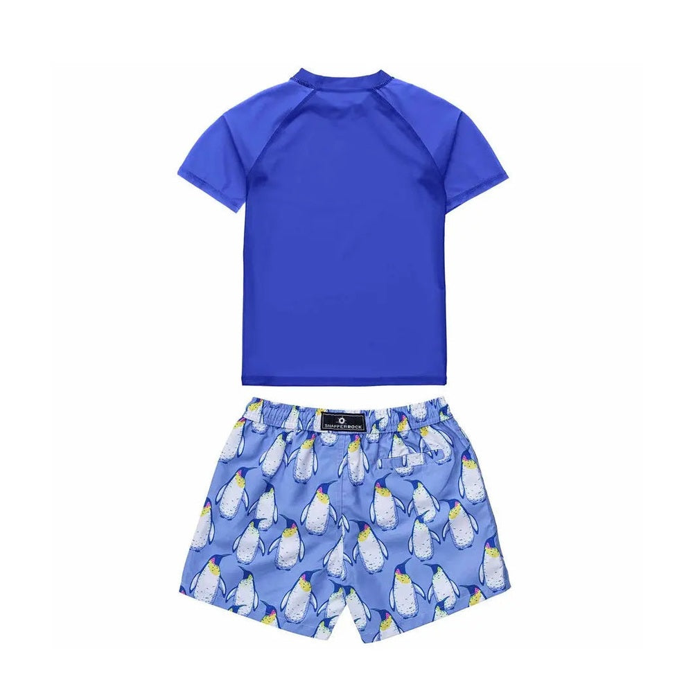 Snapper Rock Penguin Patrol Ss Baby Set: blue short-sleeve rash guard paired with penguin-print swim shorts, ready for splash.