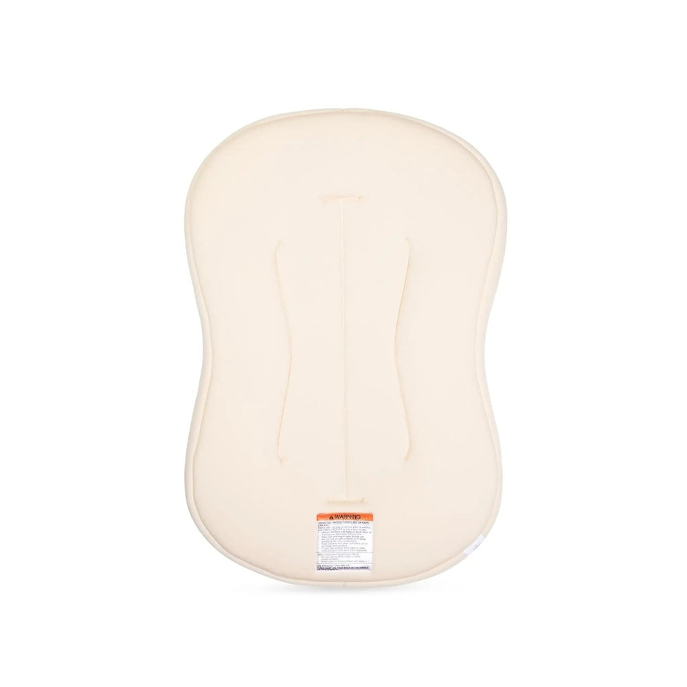 Snuggle Me Organic Lounger Curve nursing pillow in cream, curved shape for cradle-like support.