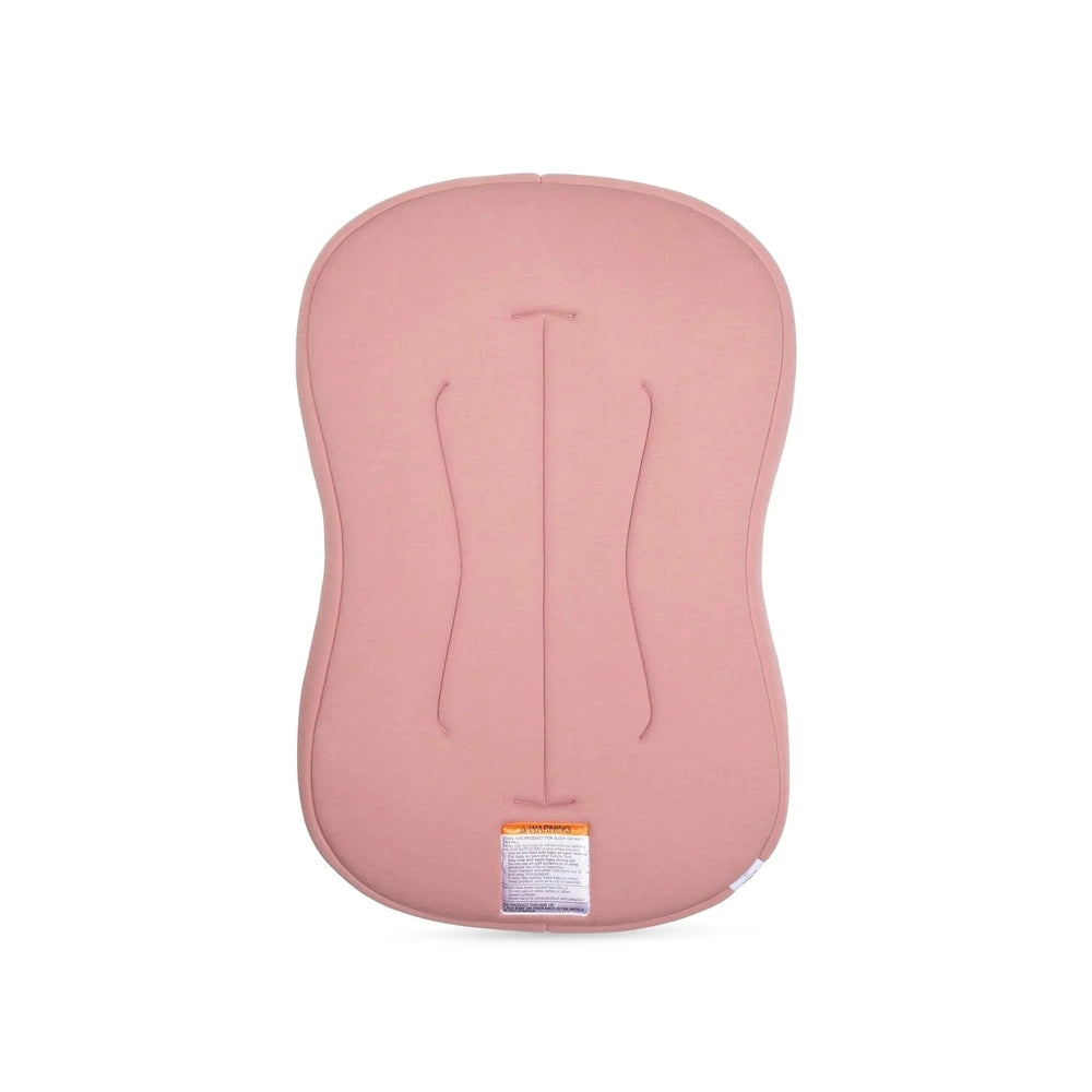 Snuggle Me Organic Lounger Curve pink nursing pillow with curved shape and soft fabric, tag visible.