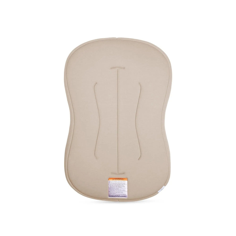 Snuggle Me Organic Lounger Curve nursing pillow in beige, curved supportive shape with a visible tag.
