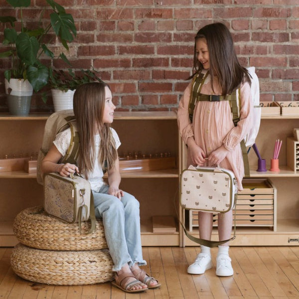 So Young Lunch Box by SOYOUNG in cream with small animal icons, carried by two smiling kids.