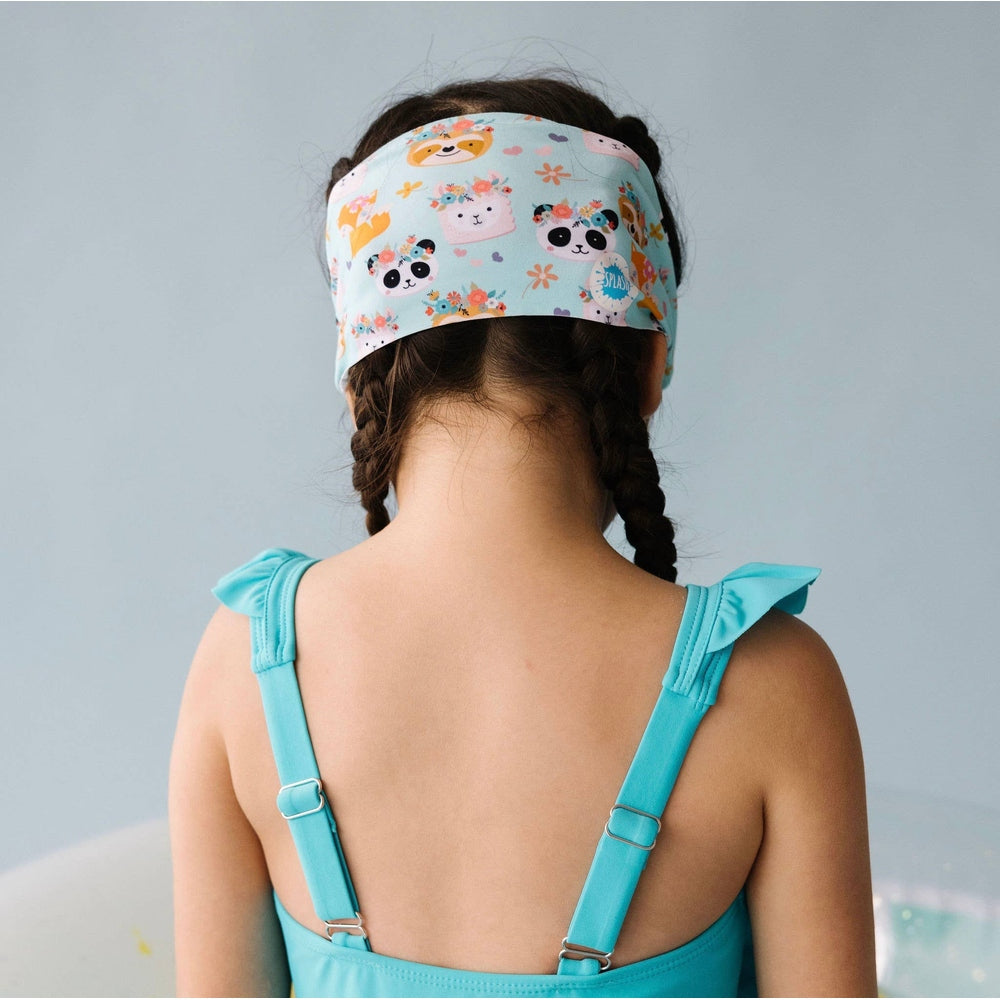 Splash Swim Goggles Forest Friends headband on child wearing turquoise swimsuit with adjustable straps
