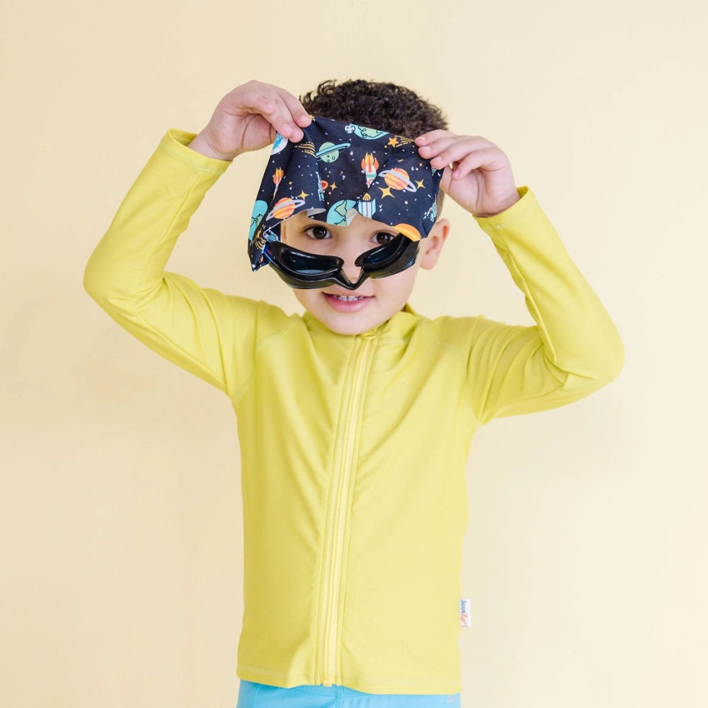 Splash Swim Goggles Galactic, child wearing space-print headband and black goggles