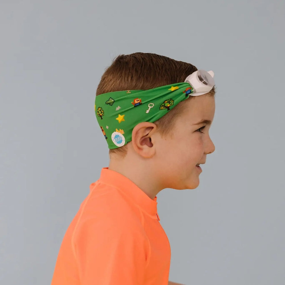 Splash Level Up Swim Goggles in White with a green printed headband, side profile of child.