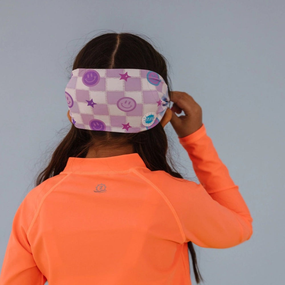Splash Swim Goggles Smiley eye mask in purple checkered pattern with smiley icons, worn by child