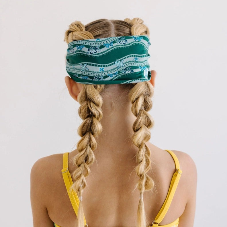 Splash Swim Goggles Turtle Turnpike headband in teal pattern on a child with blonde braids and yellow swimsuit straps