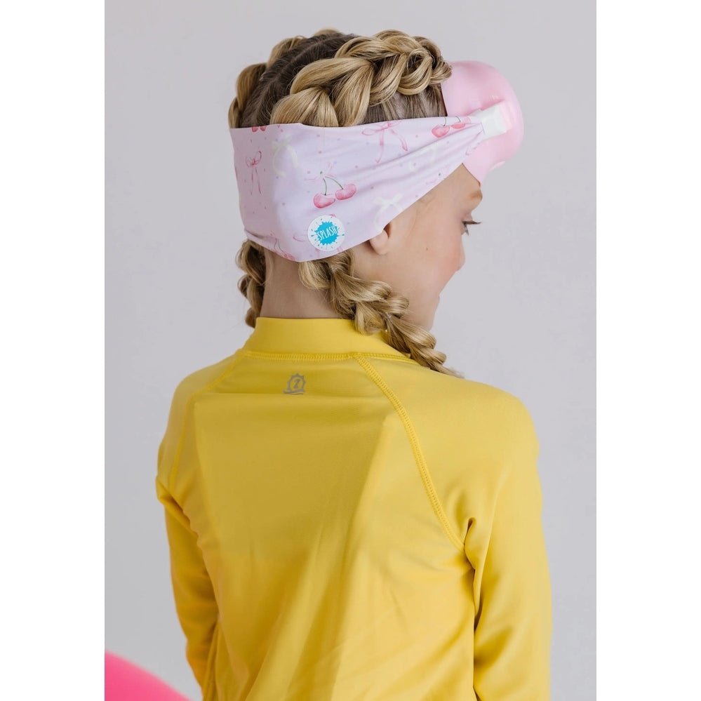 Splash Cherry Charms Youth Swim Mask Goggles in Pink on a girl with braided hair and a yellow rash guard