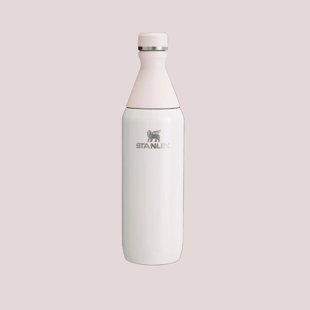 Stanley All Day Slim Bottle 34oz in white with a pale pink cap, featuring the STANLEY logo.