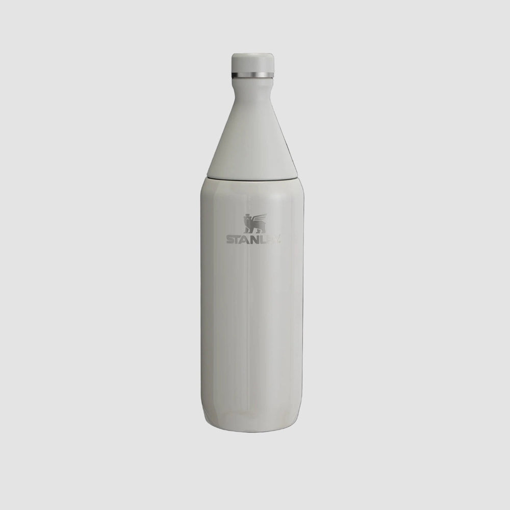 Stanley All Day Slim Bottle 34oz in white, stainless steel, with screw-on cap, standing upright.