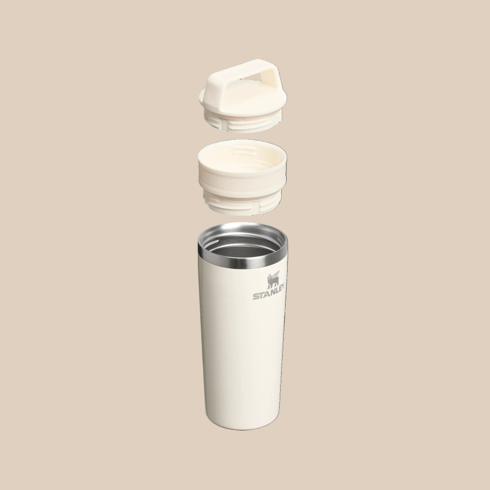 Stanley Café-To-Go Travel Mug 16 oz white, lid and cap separated to show spill-proof design and stainless interior.