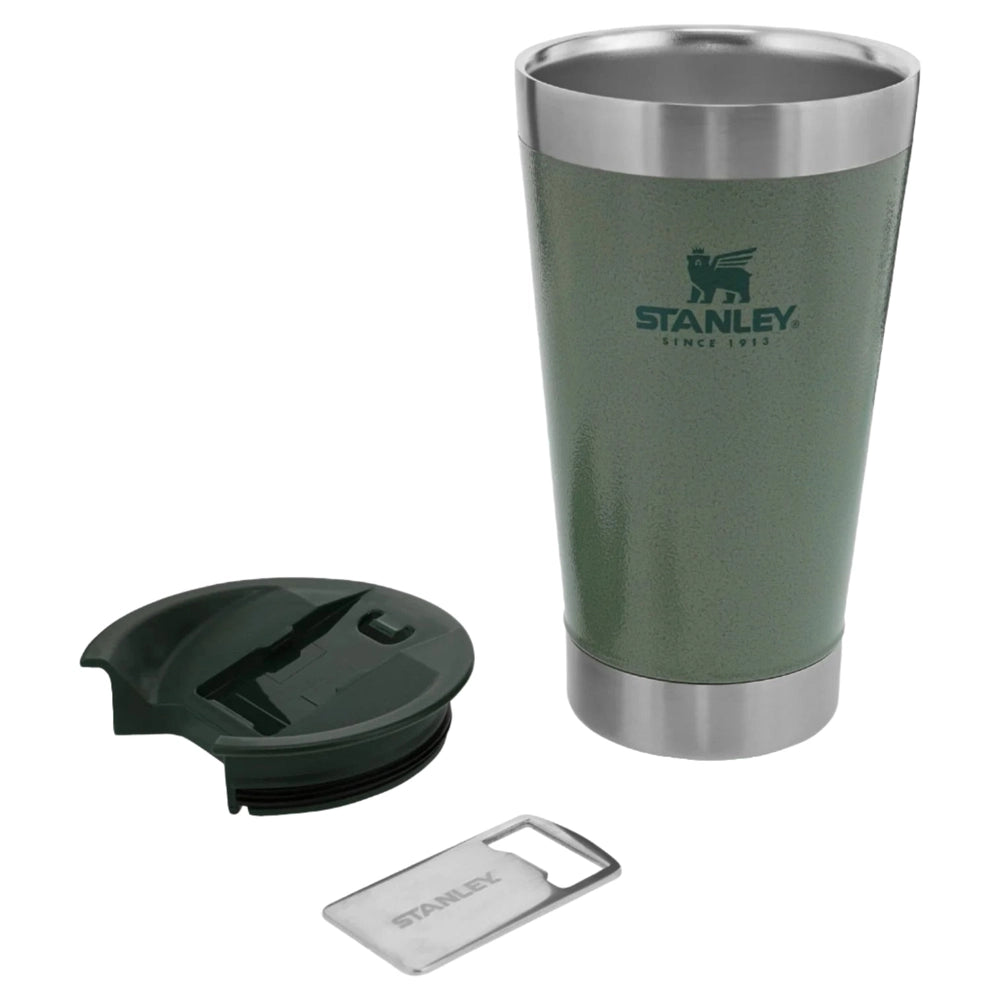 Stanley Classic Stay Chill Beer Pint 16 oz green tumbler with stainless steel rims; lid off beside it with a bottle opener.