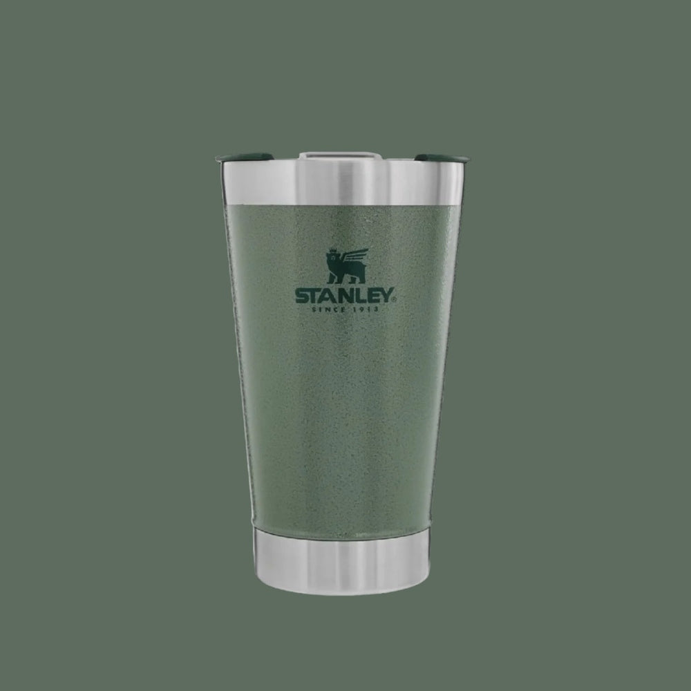 Stanley Classic Stay Chill Beer Pint 16 oz tumbler in green with stainless steel rims, condensation signals a cold drink.