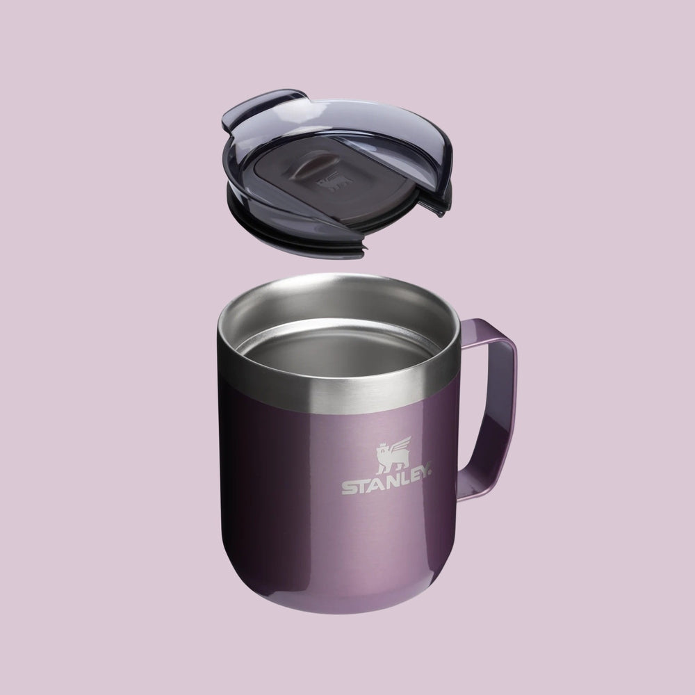 Stanley Classic Stay-Hot Camp Mug 12 oz in purple with stainless rim; lid lifted above to show spill-proof design.