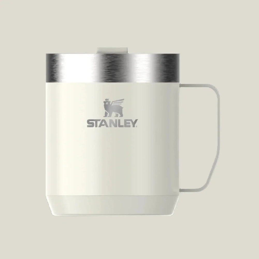Stanley Classic Stay-Hot Camp Mug 12 oz in white with stainless steel lid, handle ready for easy grabbing.
