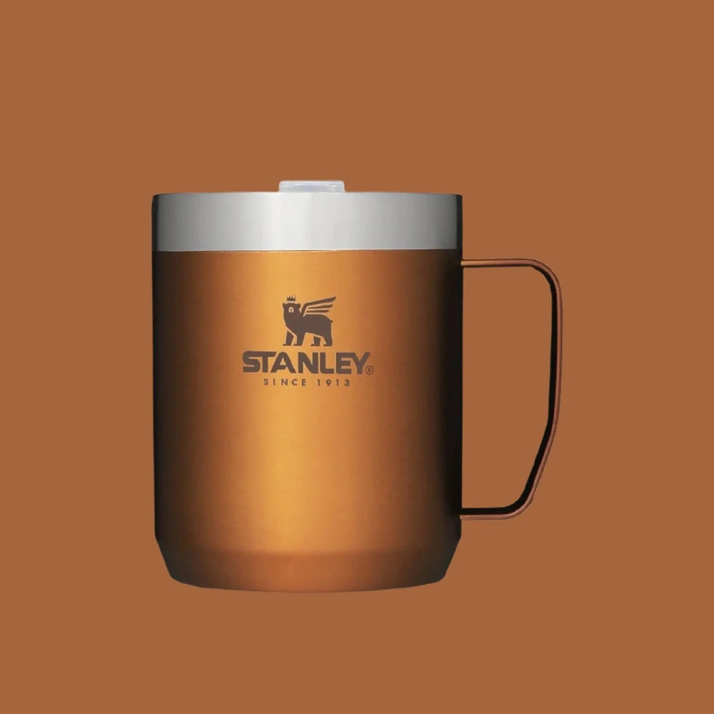 Stanley Classic Stay-Hot Camp Mug 12 oz in copper with silver lid, handle visible for on-the-go sipping.