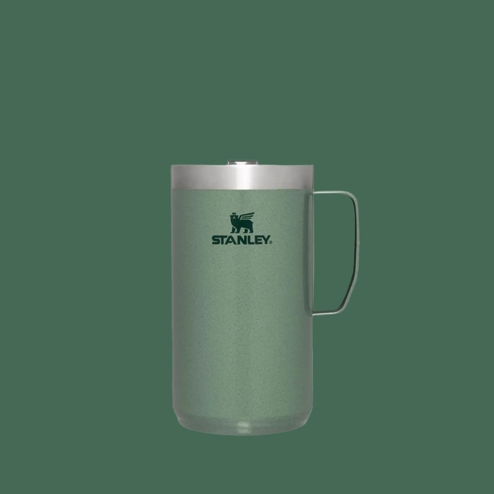 Stanley Classic Stay-Hot Camp Mug 24 oz in green stainless steel with lid and ergonomic side handle.