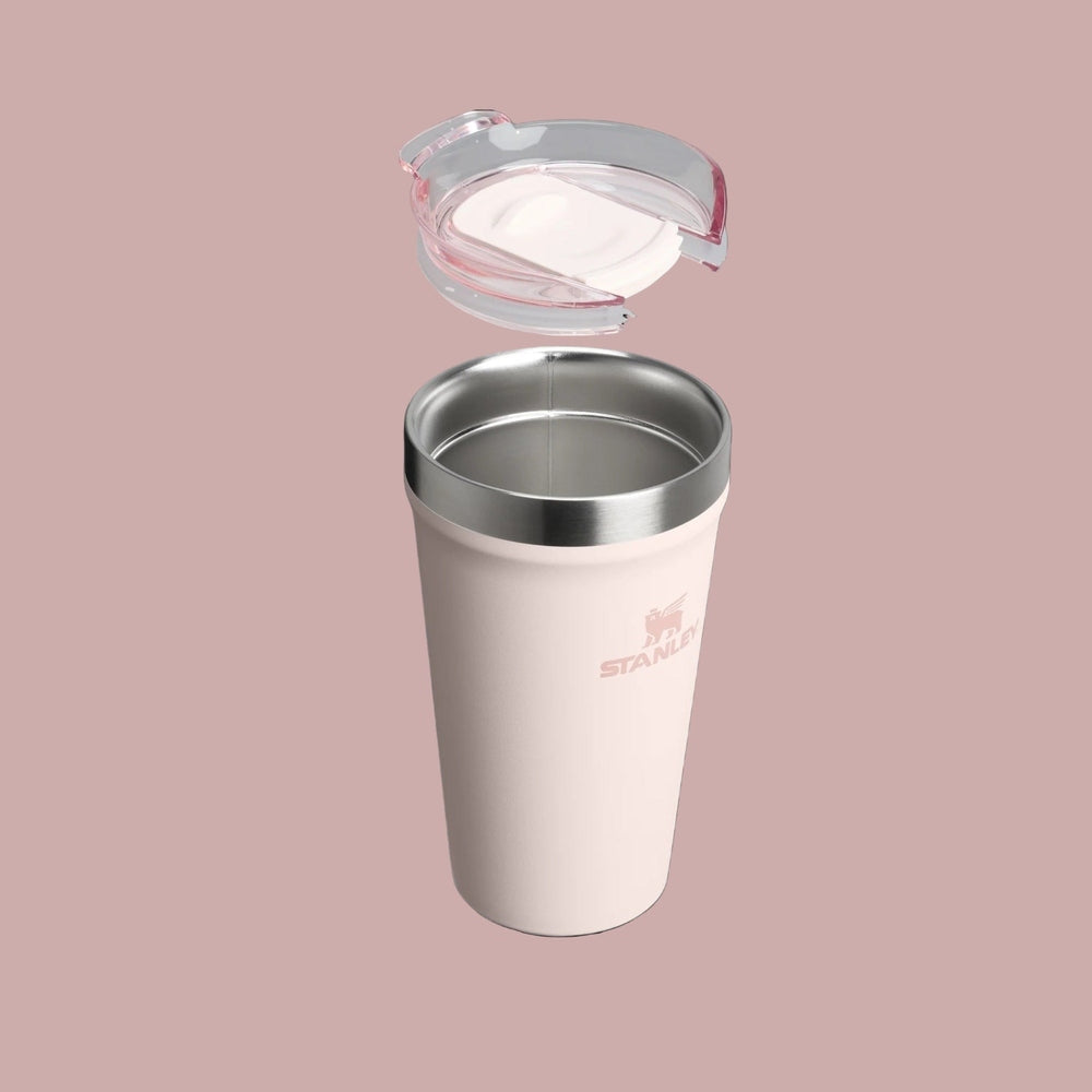 Stanley Everyday Tumbler 16oz in pink with stainless rim, lid detached above showing seal.
