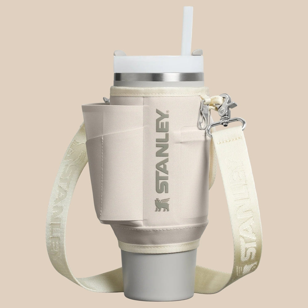 Stanley The All Day Quencher Carry-All 30 oz water bottle with cream fabric sleeve and adjustable strap