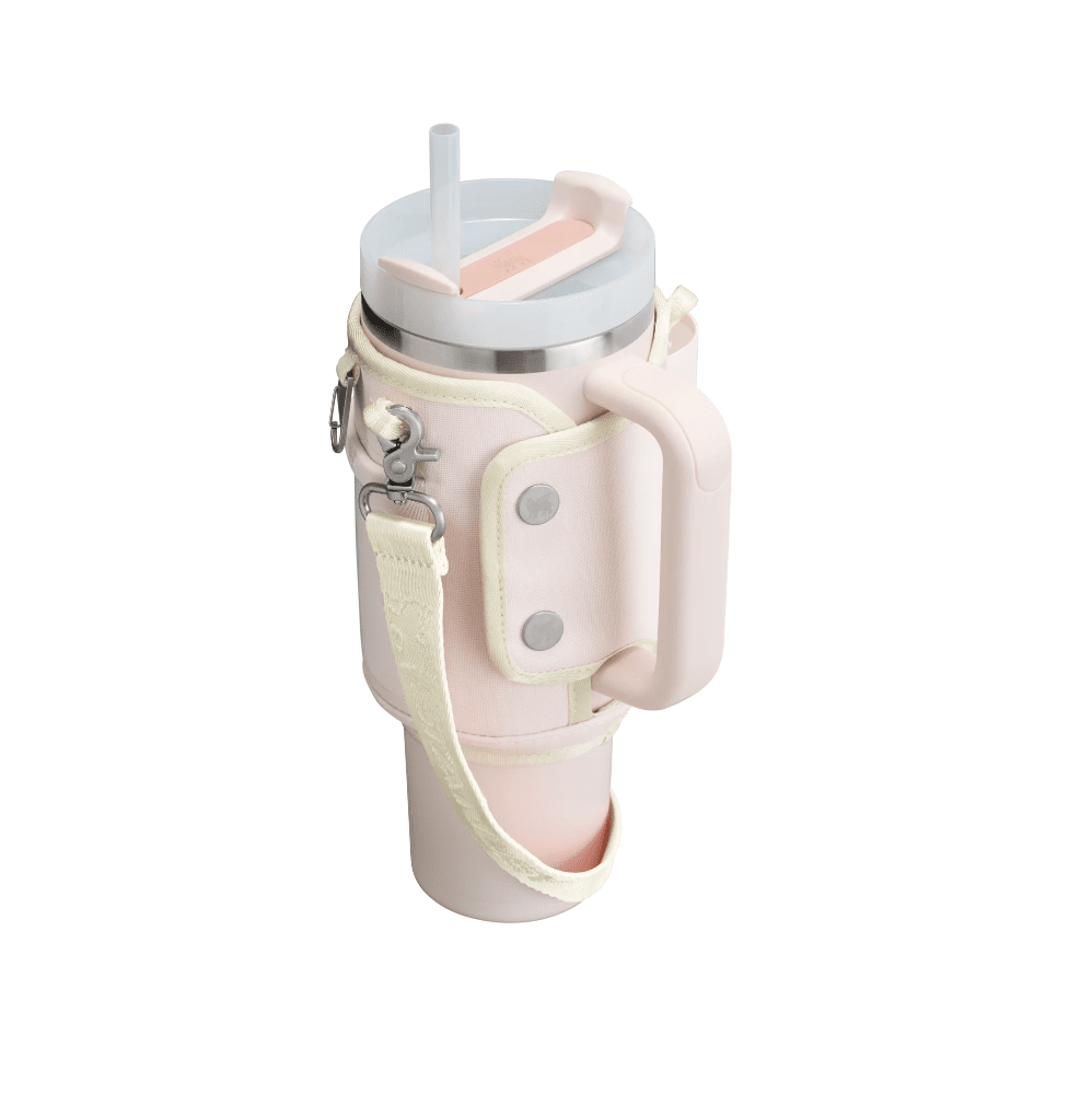 STANLEY The All Day Quencher Carry-All 40 oz water bottle in pastel pink with cream sleeve and adjustable strap