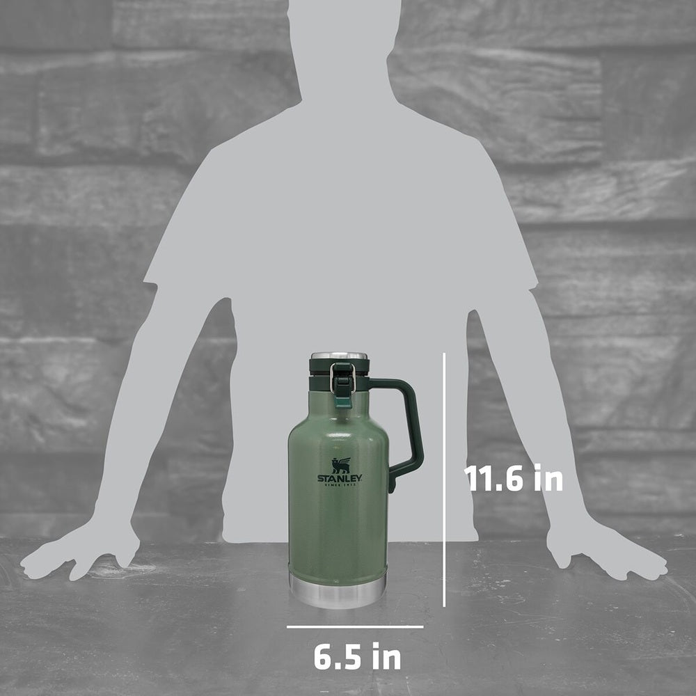 Stanley The Easy-Pour Growler 64 oz green with handle, standing on a table beside a human silhouette for scale.