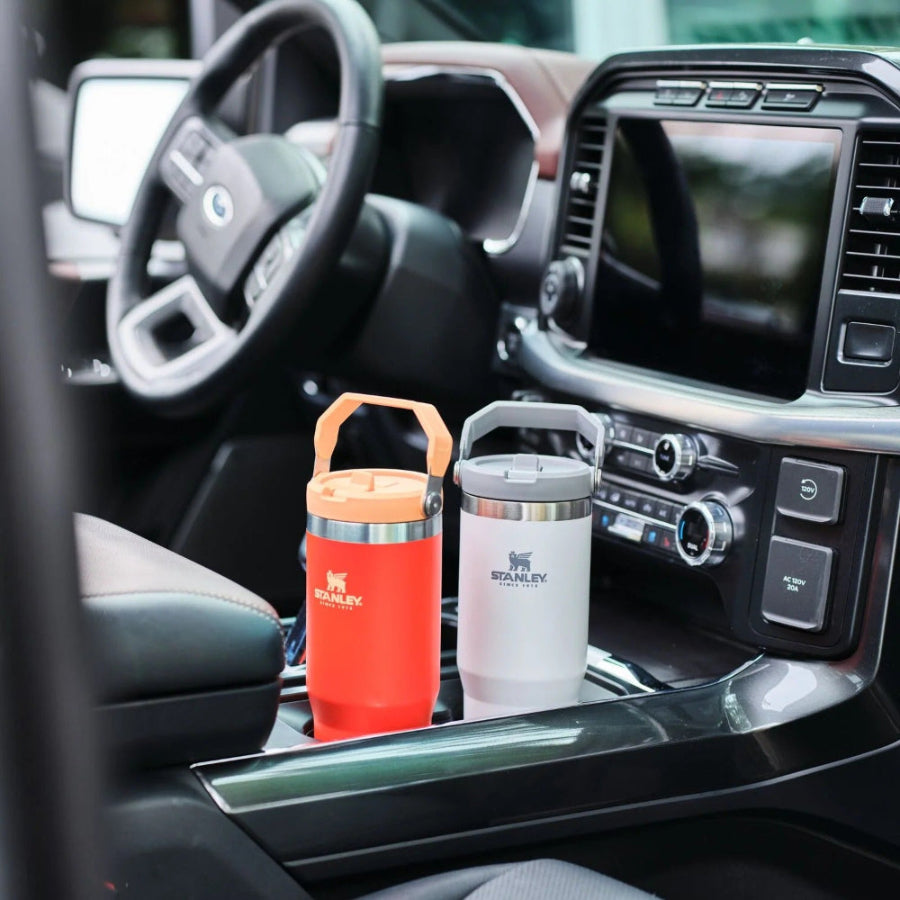 Stanley The IceFlow Flip Straw 2.0 Tumbler 20 oz orange and gray, two cups shown in car interior