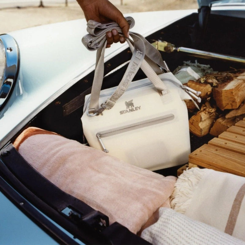 Stanley IceFlow Flip Straw 2.0 20 oz tumbler with gray strap in car trunk