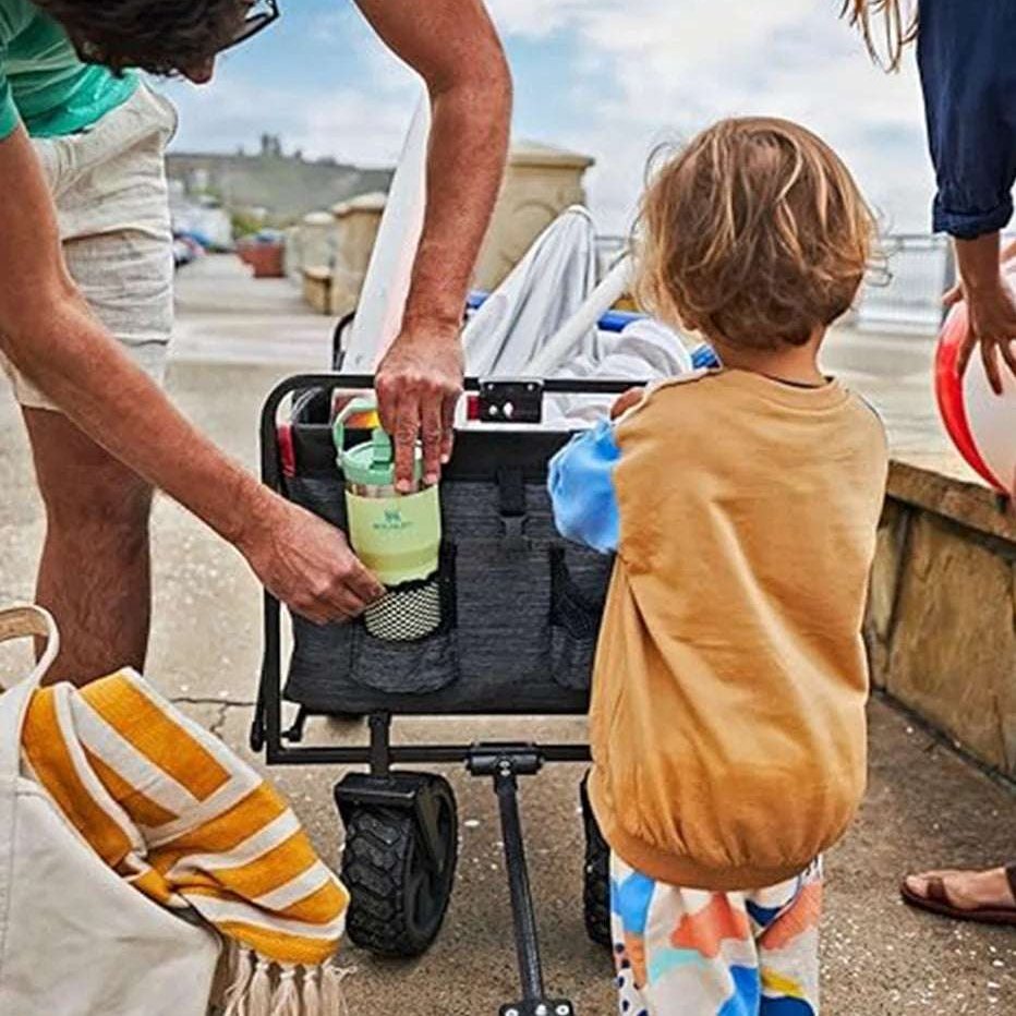 STANLEY IceFlow Flip Straw Tumbler 20 oz with green flip straw in a stroller organizer at the beach