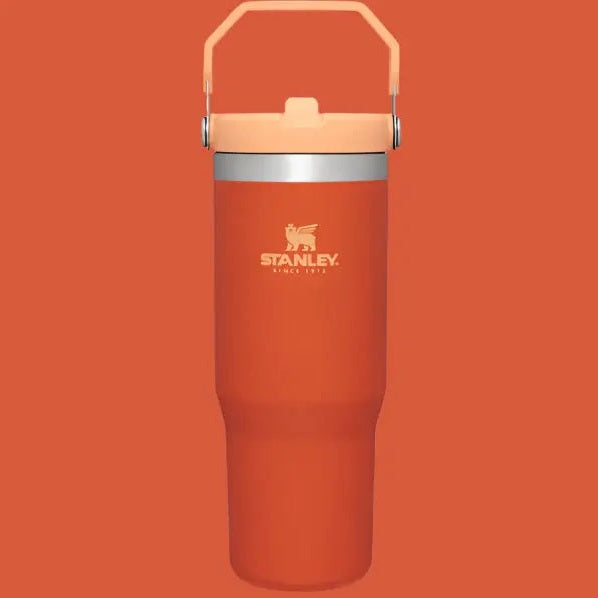Stanley The Iceflow Flip Straw Tumbler 30 oz in orange with matching lid, raised handle, and logo.