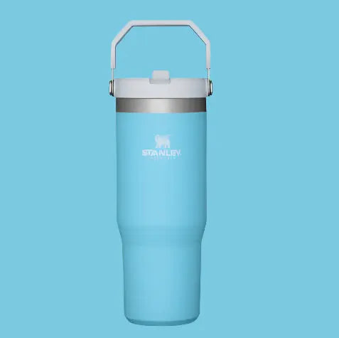 STANLEY The Iceflow Flip Straw Tumbler 30 oz in blue, silver lid, carry handle raised for easy transport