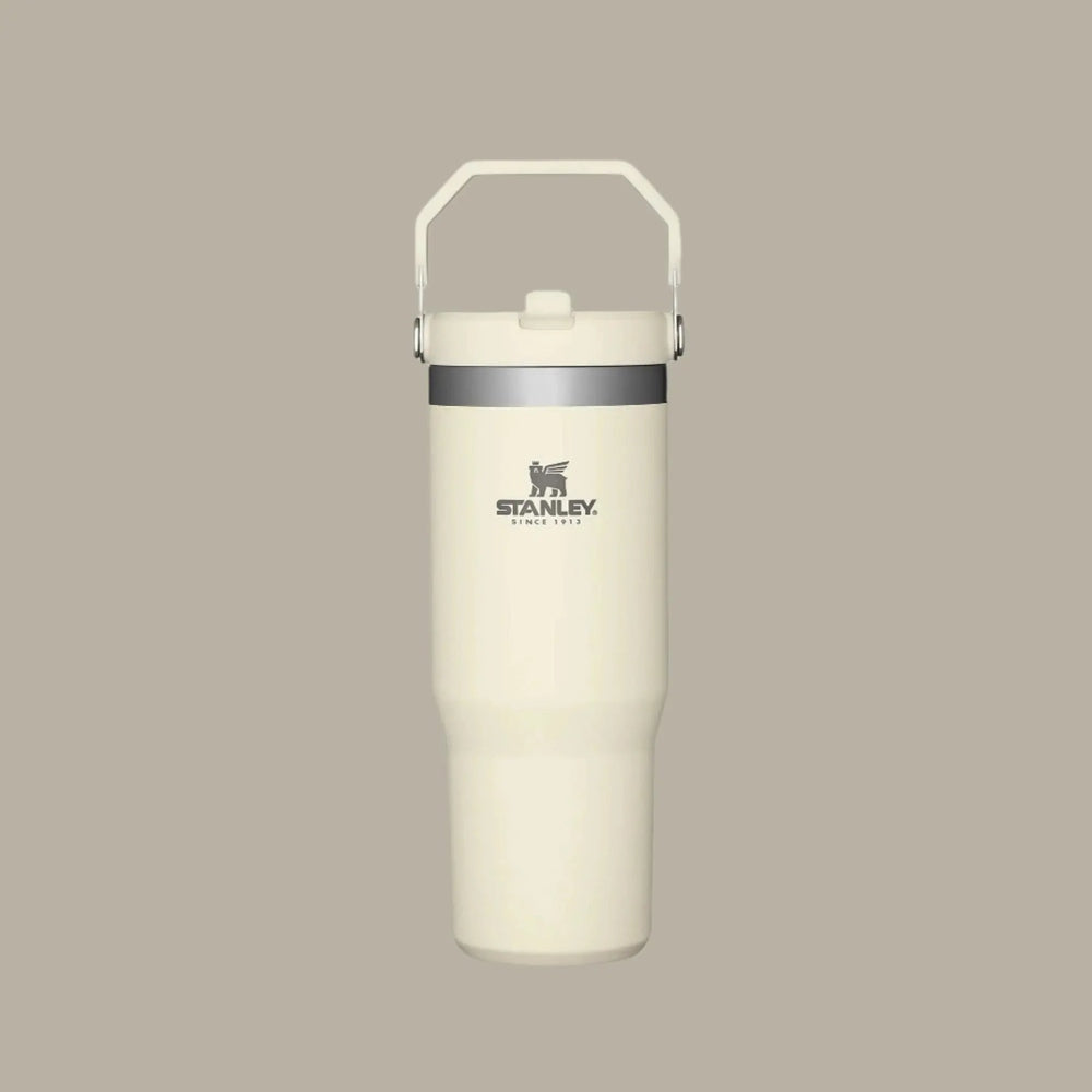 Stanley The Iceflow Flip Straw Tumbler 30 oz in cream with gray band; built-in handle for easy carrying and flip straw lid.