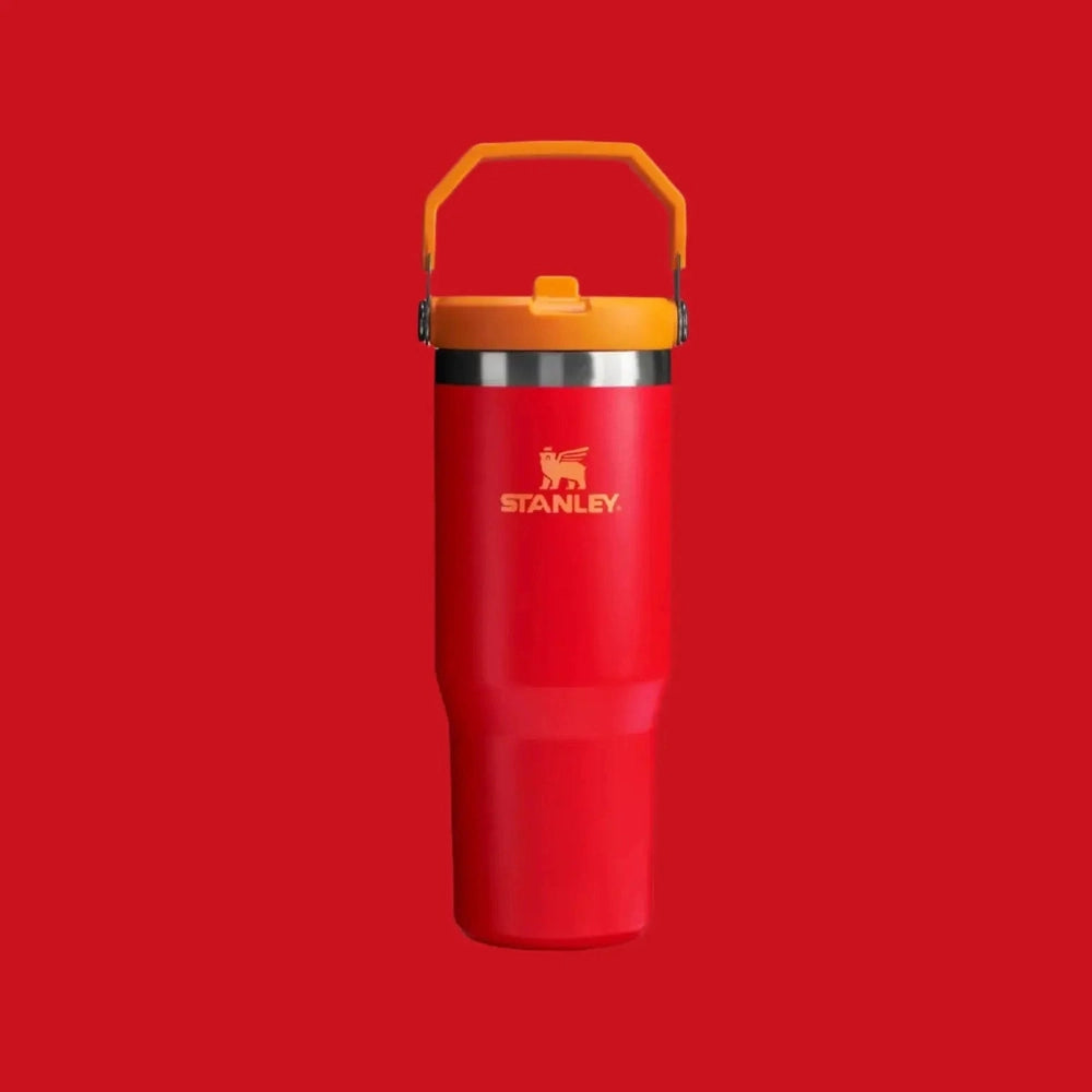 Stanley The Iceflow Flip Straw Tumbler 30 oz red with orange lid; carried by its bright orange handle.