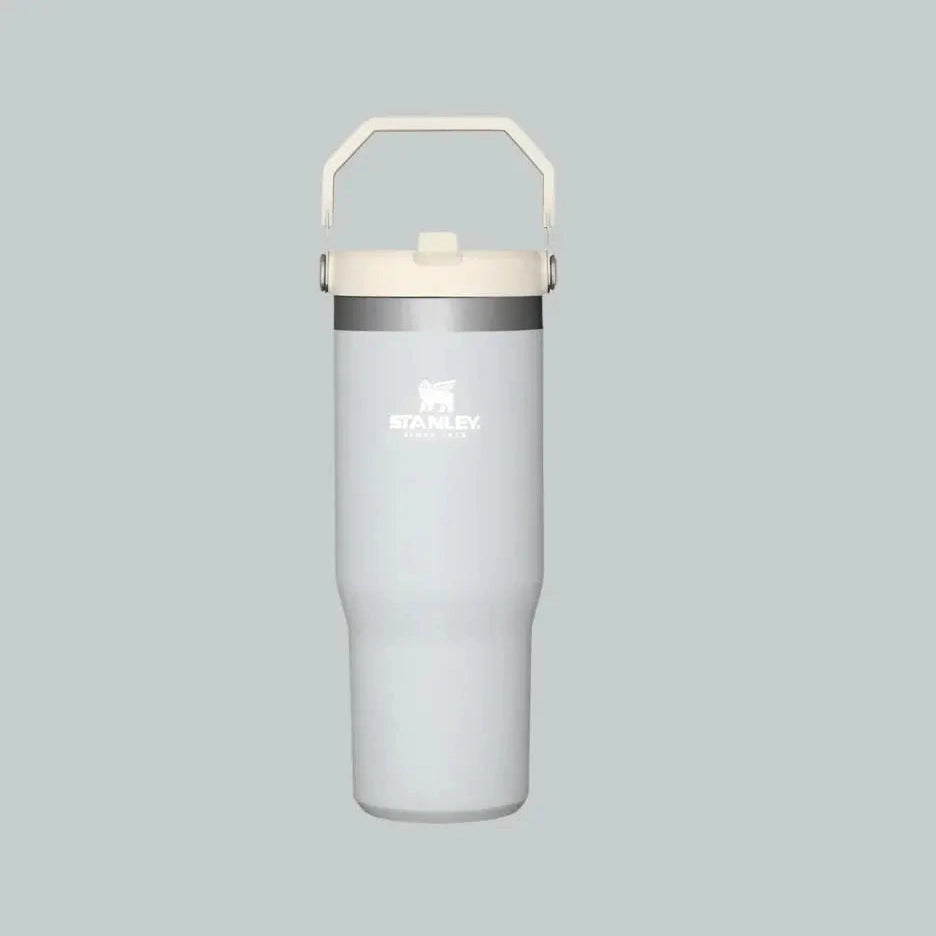 Stanley The Iceflow Flip Straw Tumbler 30 oz in light gray with white lid and integrated handle, flip straw lid raised.