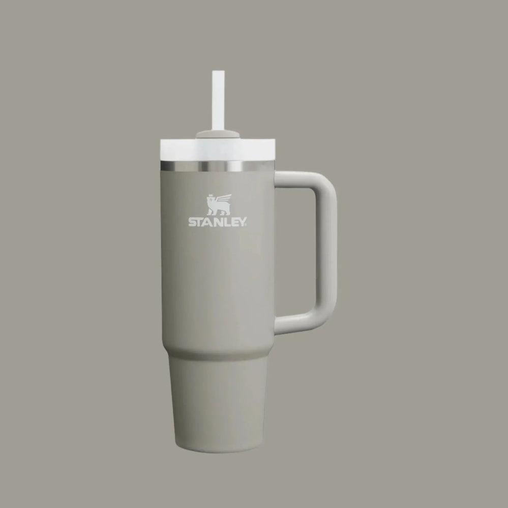 Stanley The Quencher H2.0 Flowstate Tumbler 30 oz in gray with white lid, straw raised, sturdy handle visible.