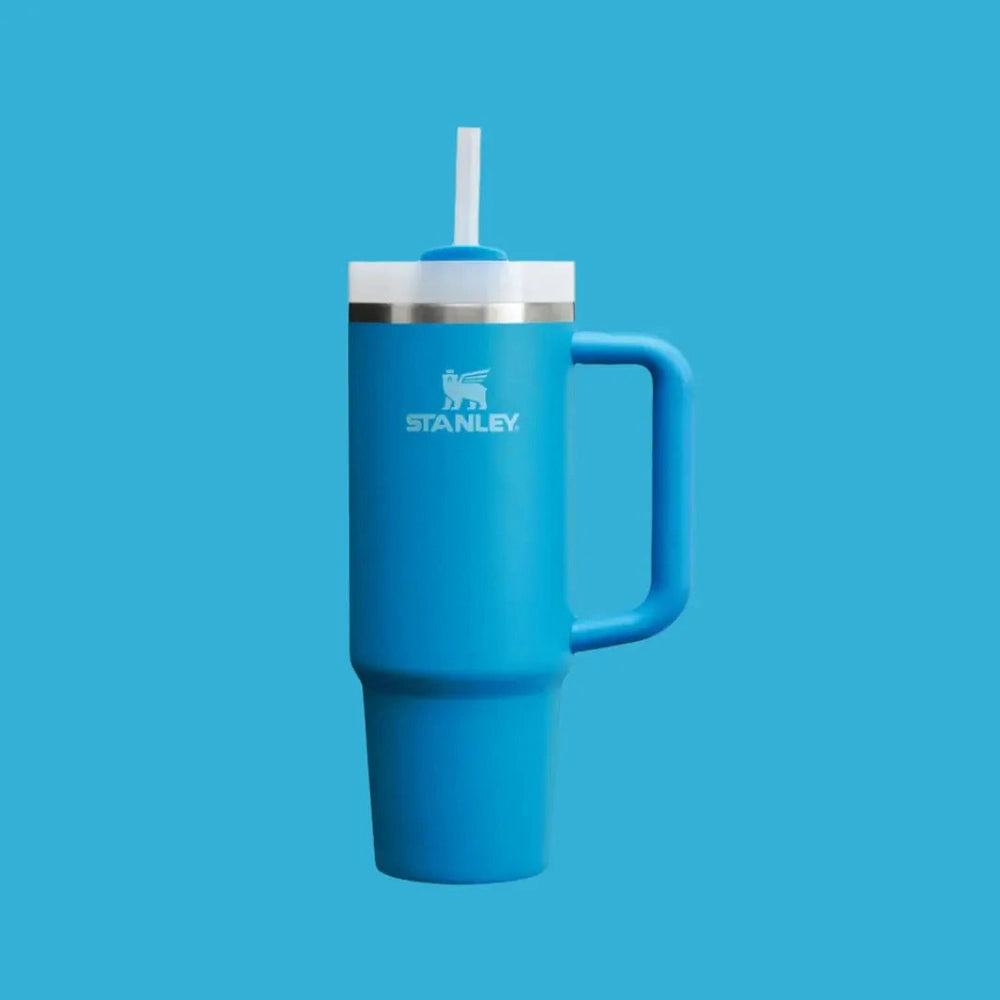 Stanley The Quencher H2.0 Flowstate 30 oz blue tumbler with straw in lid and sturdy handle, ready to sip.