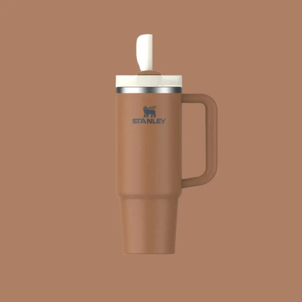 Stanley The Quencher H2.0 Flowstate Tumbler 30 oz in brown with cream lid; spout flip open, handle visible.