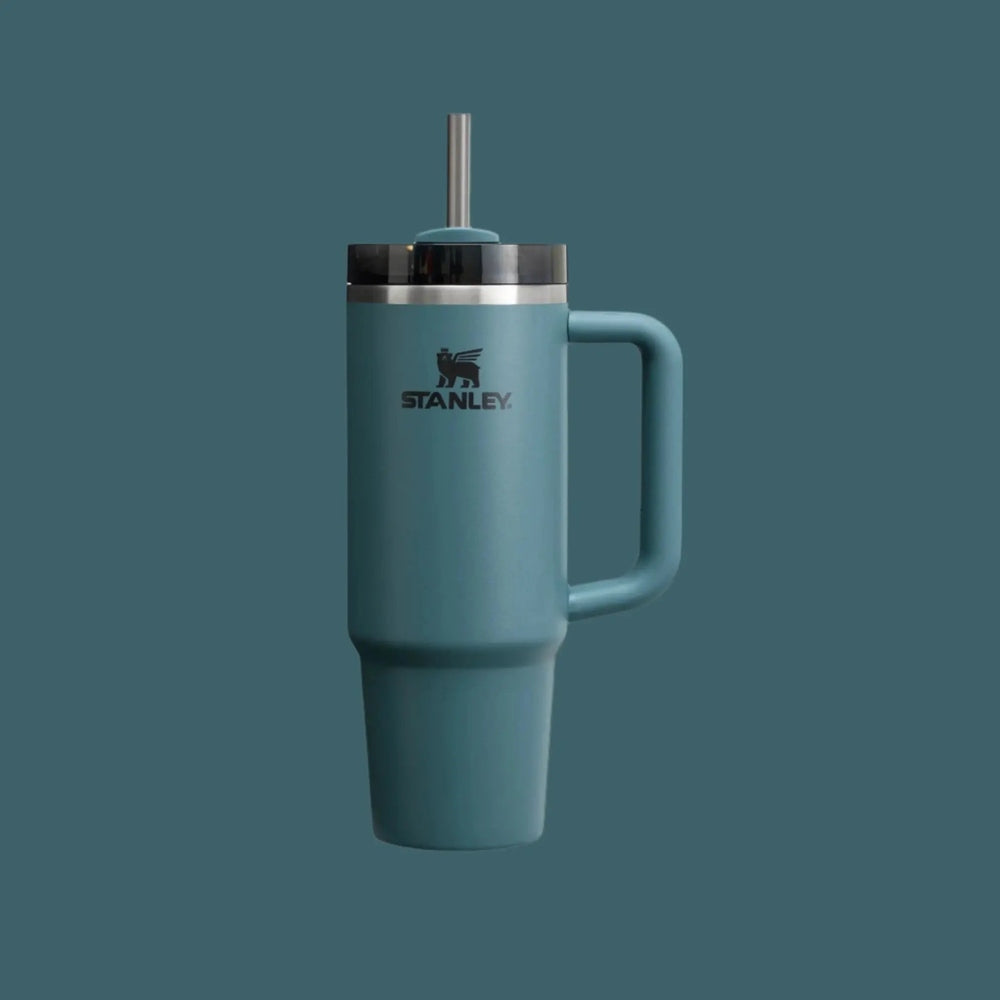 Stanley The Quencher H2.0 Flowstate Tumbler 30 oz in teal with handle, stainless lid, straw raised for sipping.