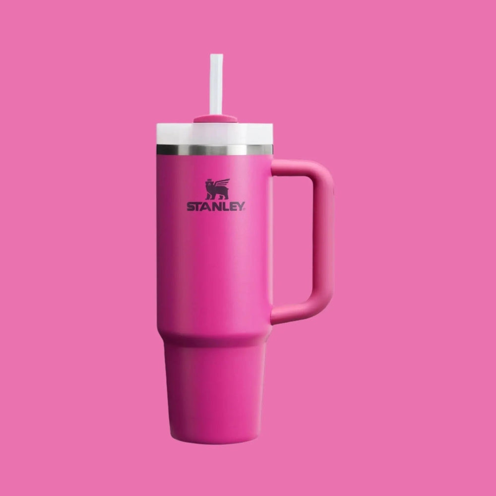 Stanley The Quencher H2.0 Flowstate 30 oz pink tumbler with straw lid being used for sipping.