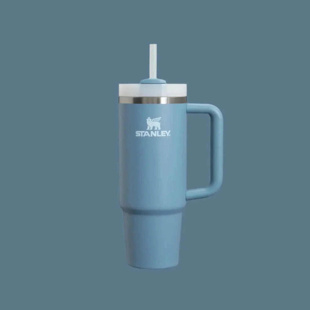 Stanley The Quencher H2.0 Flowstate Tumbler 30 oz in blue with straw lid and handle, straw ready for sipping.