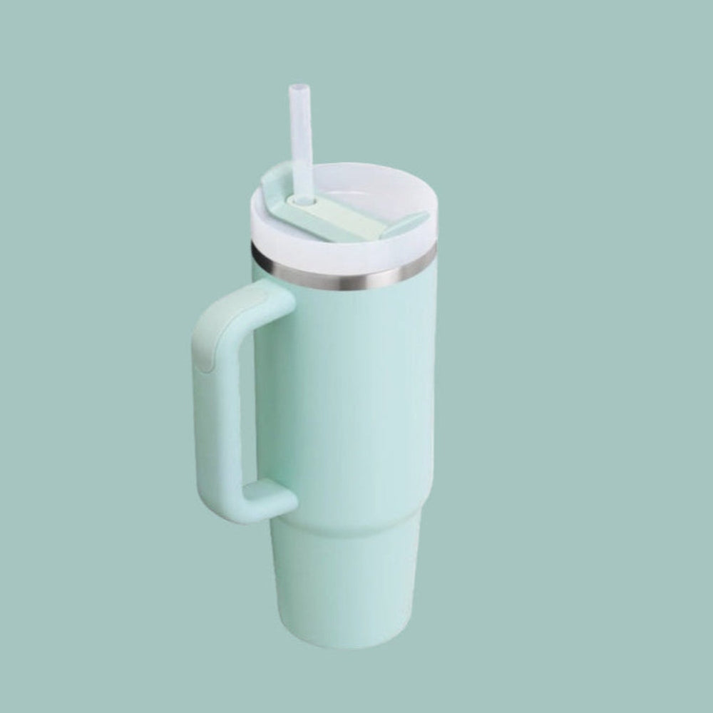 STANLEY The Quencher H2.0 Flowstate Tumbler 30 oz in mint green, with straw and lid showing easy sipping and secure closure.