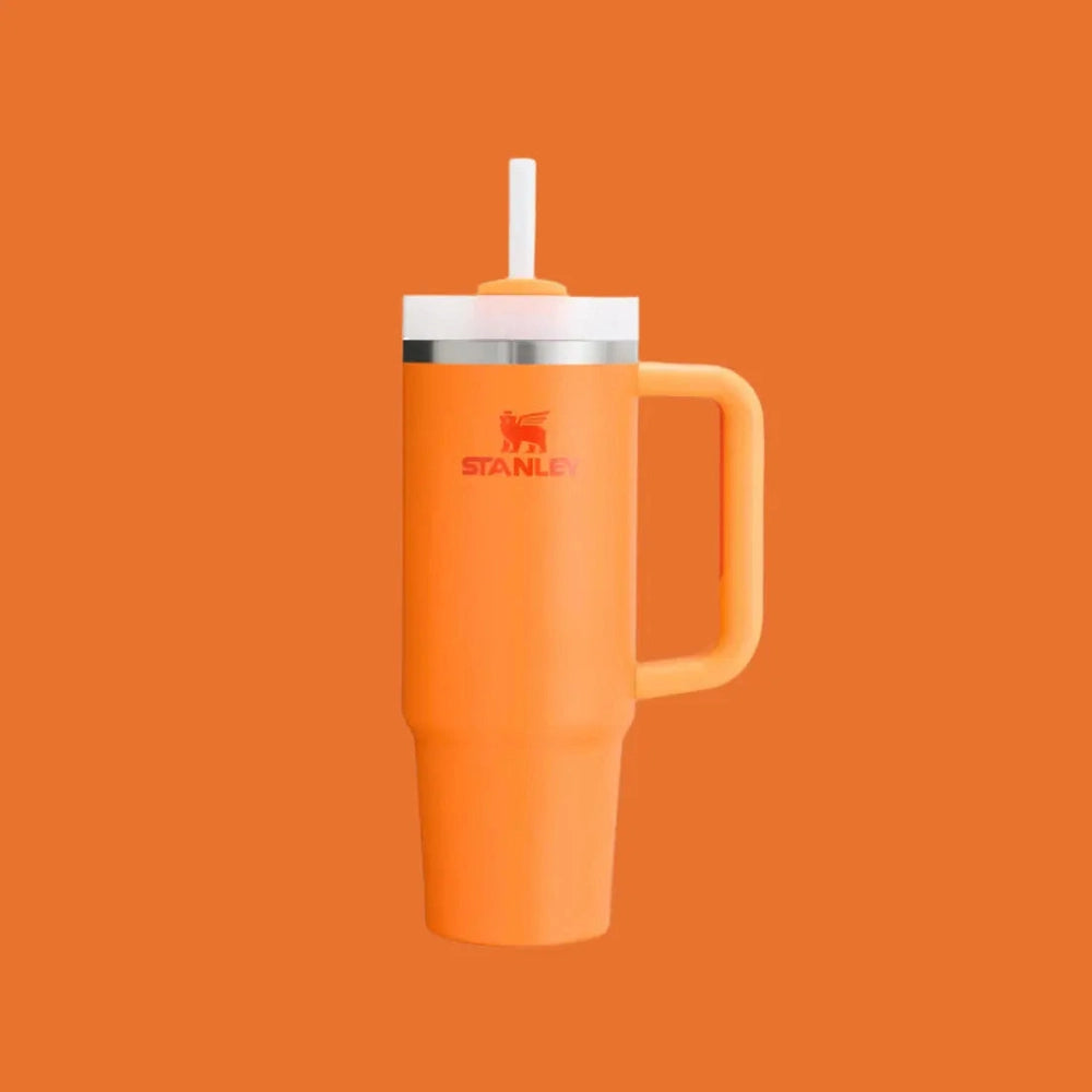 Stanley The Quencher H2.0 Flowstate Tumbler 30 oz orange with white lid and extended straw for easy sipping.