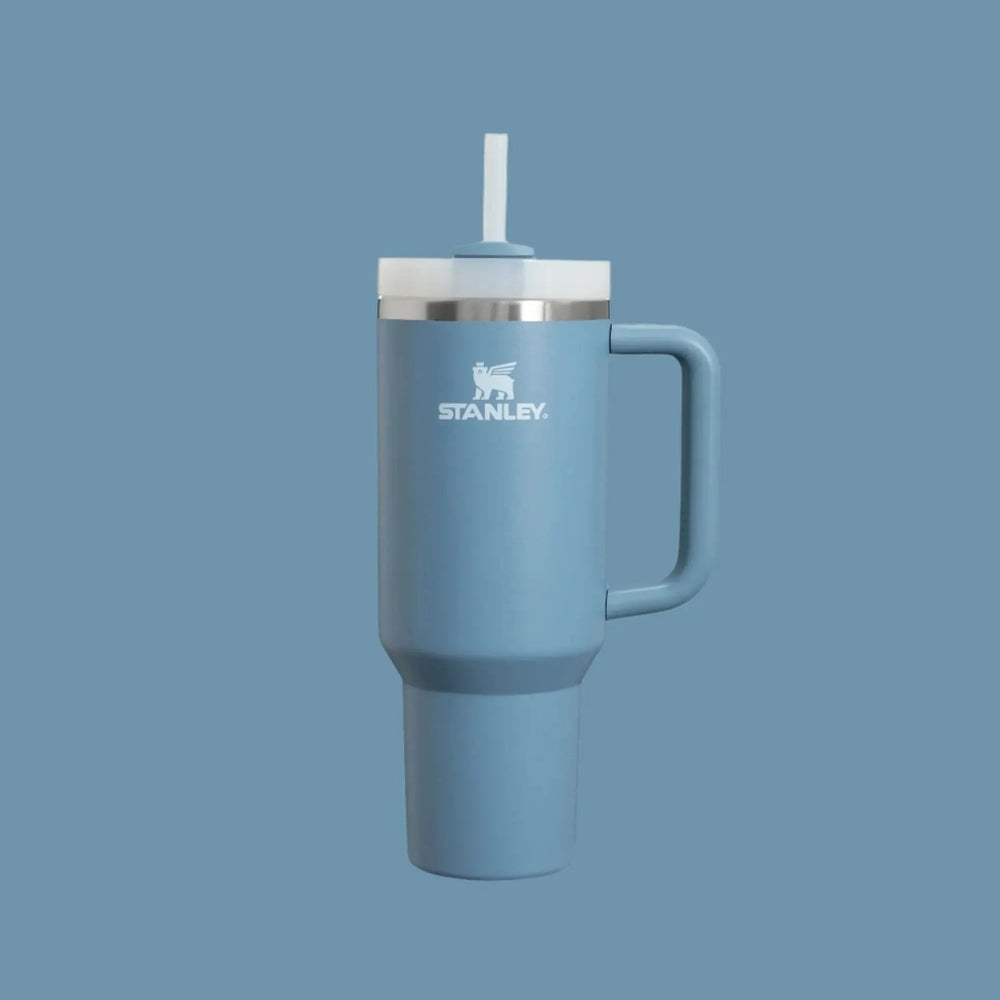 Stanley The Quencher H2.0 Flowstate 40 oz tumbler in blue with straw in lid and easy-grip handle.